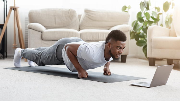 black man working out online at computer